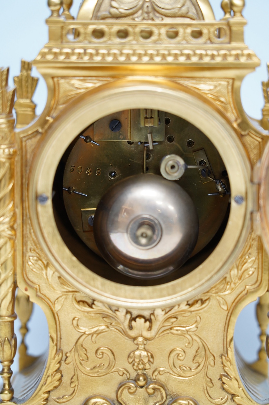 An early 20th century French ormolu mantel clock with key and pendulum, 33cm. Condition - good, not tested as working